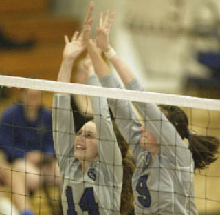 Serah Peterson (14) and Megan Rainey (9) go up for a block against Port Angeles Tuesday. The Lady Trojans beat NK 3-2 Thursday.