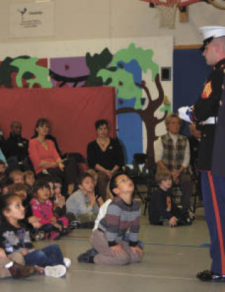 Students at Emerald Heights Elementary School watch intently as members of three military branches present a flag detail during the reading of “Old Glory” Tuesday. Students at Emerald Heights Elementary School watch intently as members of three military branches present a flag detail during the reading of “Old Glory” Tuesday.