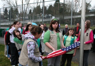 Local Girl Scouts retire the flags at the Warren Avenue office Sunday