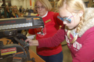 Fairview junior high seventh grader Haley Woodward cuts details for her step stool at the Pizza