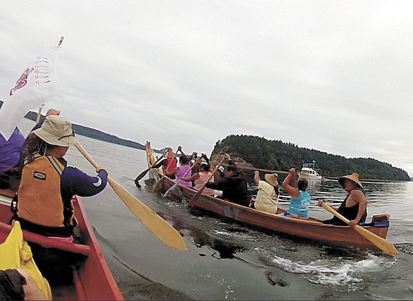 Canoes head from Nisqually’s territorial waters to the territory of the Squaxin Island Tribe