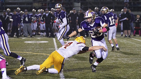 North Kitsap’s TJ Jensen avoids being tackled by the Kingston Buccaneer defense Oct. 17 during the Pillage and Plunder Bowl at North Kitsap Stadium. The Vikings remain unbeaten this season and are two games away from securing the Olympic League title.