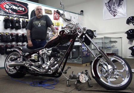 Paul Marshall of Road Rider Supply stands by his Big Dog K-9 custom chopper