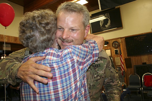 Lt. Barry Doll hugs Evie Vandenberg during his welcome home event at VFW Post No. 239.