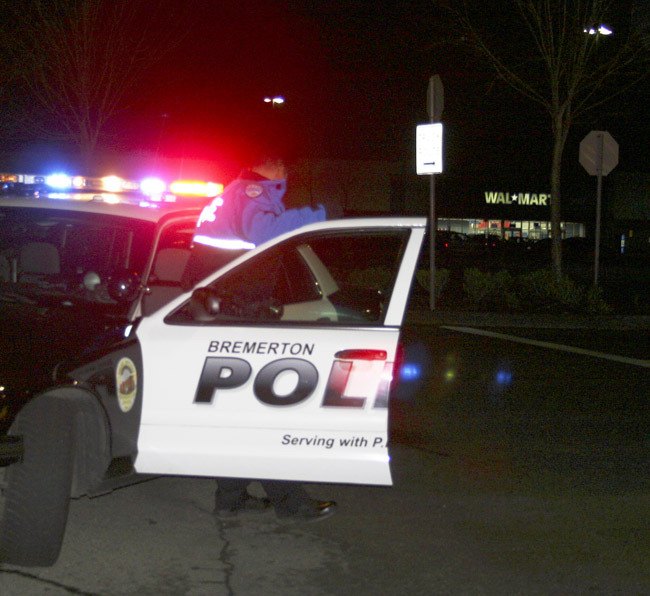 A Bremerton police cruiser maintains crowd control in the Port Orchard WalMart parking lot