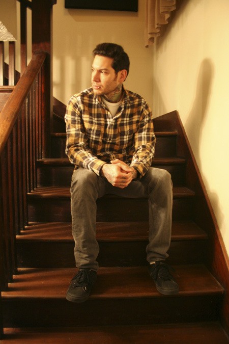 Mike Herrera is pictured in the stairway of his Bremerton recording studio earlier this month where his band Tumbledown records. The country punk band will head to Japan and Mexico in the new year