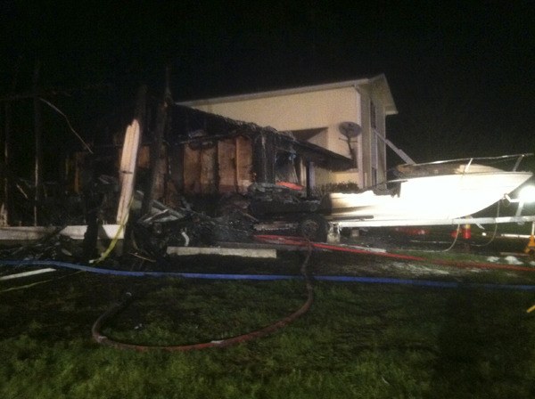 A man injured after a garage fire spread into a home in Indianola.