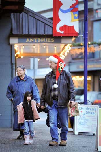 Ed and Louise Lewis walk their grandchildren Mia and Dieigo through downtown Poulsbo Monday in search of Christmas gifts.