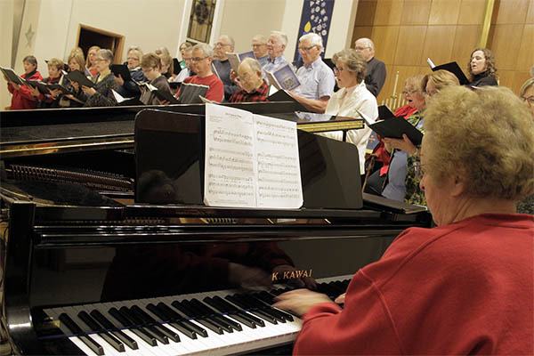 Pianist Miriam Haddon and the Poulsbo First Lutheran Church choir prepare Dec. 2 for the upcoming Community Concert.