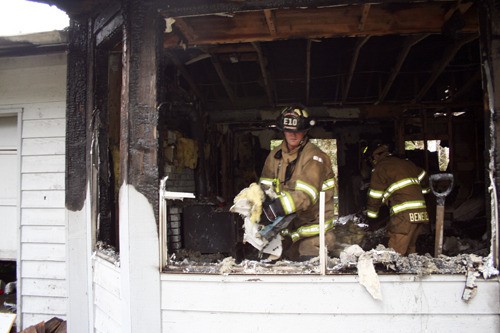 South Kitsap Fire and Rescue workers cleared insulation out of a burnt Manchester house.