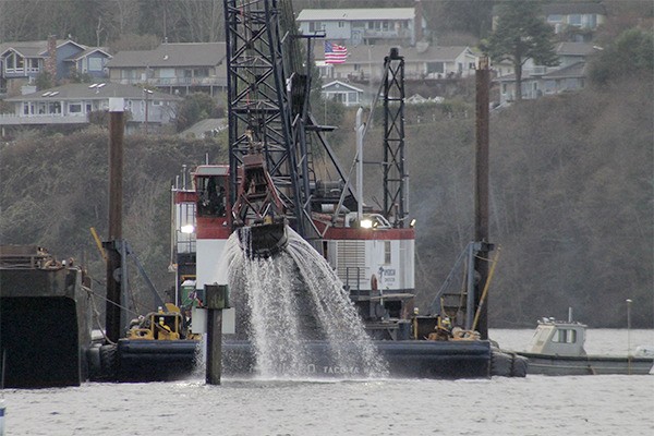 The dredge barge operated by American Construction Company pulls sediment from the Kingston marina