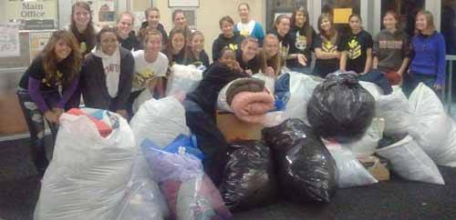 The North Kitsap girls soccer team pose with bags of clothes that were later donated to North Kitsap Fishline.
