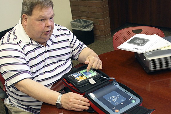 Officer Robbie Davis shows off one of the Bremerton Police Department’s new Automated External Defibrillators.