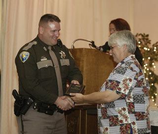 MADD Kitsap Chapter President Marsha Masters presents Kitsap County Sheriff's Deputy Lee Wheeler with a plaque