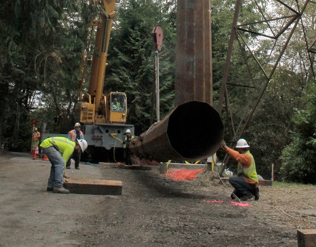 Crews work to raise a new power pole on Bainbridge Island that will hold upgraded lines from North Kitsap.