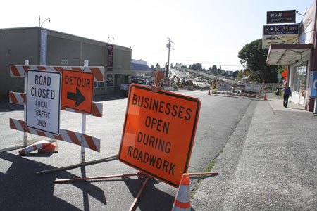 Road closure and “businesses open” signs are pictured on Harkins Street in Manette. Since the Manette Bridge closure in July