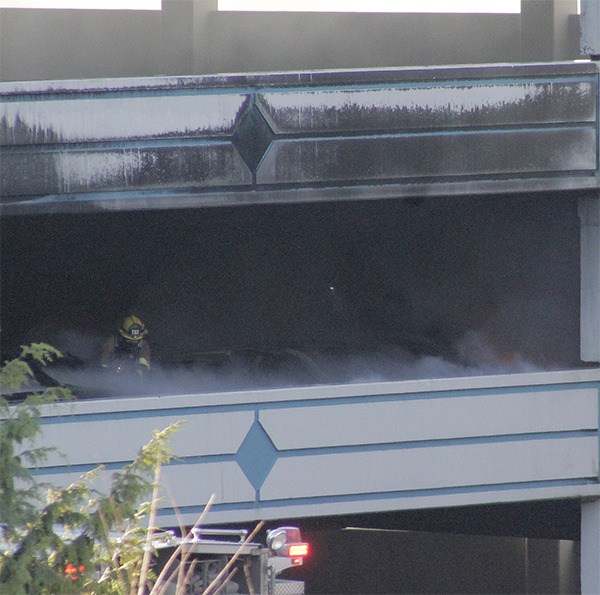 Firefighters work to extinguish a car fire on the fourth floor of the older parking garage at Suquamish Clearwater Casino Resort