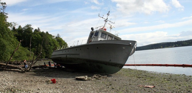 A 60-foot wooden boat washed ashore on the east side of Port Gamble Bay on Thursday.