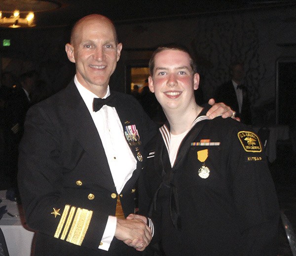 Cadet Kyle Brockman (right) of the United States Naval Sea Cadet Corps Kitsap Battalion unit is presented the Navy League of the United States (NLUS) Theodore Roosevelt Youth Award by Vice Admiral Frank Caldwell