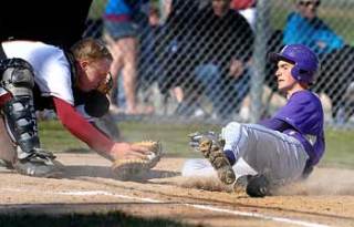 North Kitsap's Zac Smit is tagged out at home by Kingston's Curtis Wildung during action at Kingston on April 27.