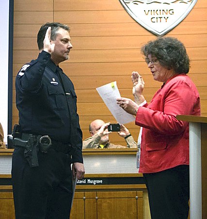 Sgt. Troy Grossman is sworn in by Mayor Becky Erickson on March 4.