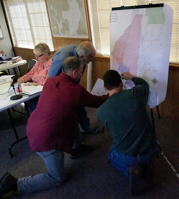 Port commissioners Tony DeCarlo and Jim Rutledge and Port Manager Brad Miller review an area map to plan expanded boundaries of the port district