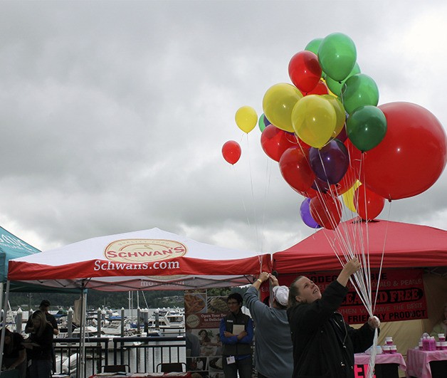 An unidentified woman holds a bouquet of balloons at the Kitsap Harbor Festival. The festival was held at both the Port Orchard and Bremerton marinas over the weekend.