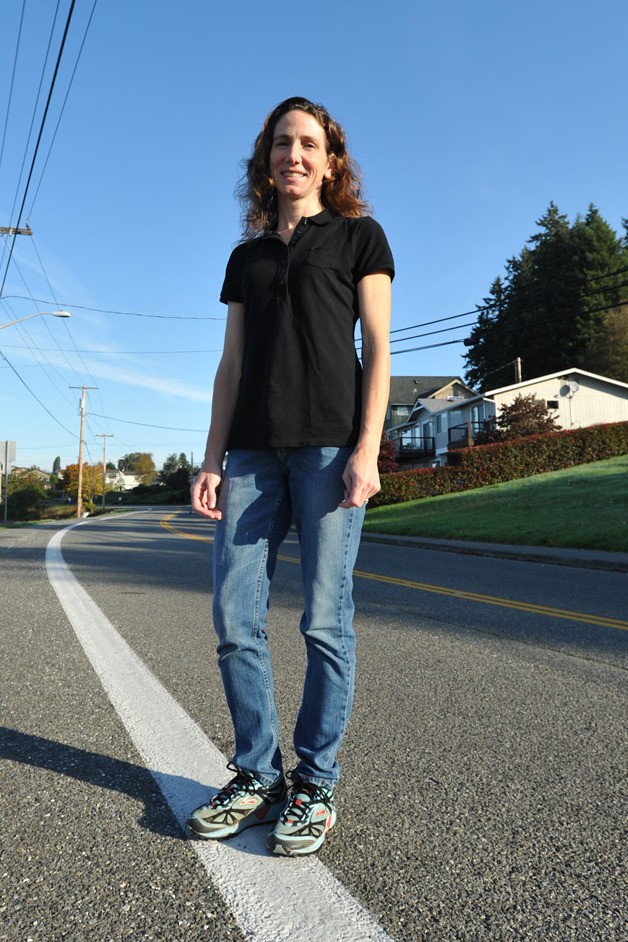 Michelle Woodward stands on Fjord Drive in Poulsbo. The stretch of road is part of the Poulsbo Marathon.