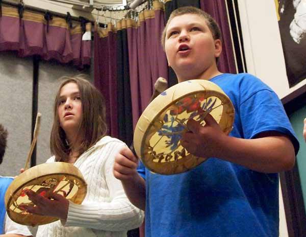 Wolfle students Jenna Jones and Alex Pavloff practice the “Welcome Song” May 20 in Michael McCurdy’s music room. The drums they are using were made from kits purchased with grant money. The students will take their drums home at the end of the school year.