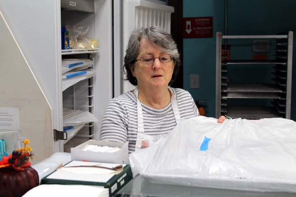 Martha Hofmann checks some baked goods Friday at Gluten-Free Bakery and Market in Poulsbo. The bakery and market's last day of business is Saturday.