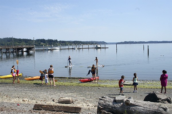 Kayakers and Paddleboarders enjoy the warm weather recently on the waters of Dyes Inlet. Paddle Kitsap begins at the inlet Aug. 10.