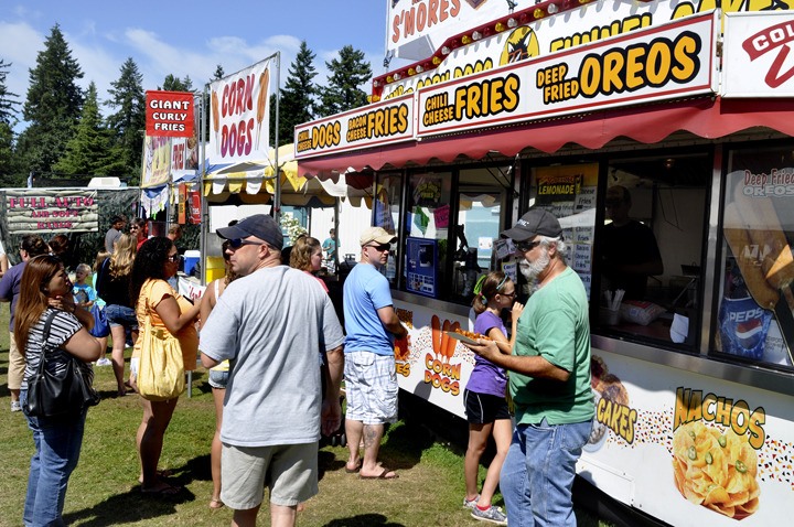 Fair visitors take in the many food vendors during the 2011 Kitsap County Fair and Stampede at the Kitsap County Fairgrounds. Organizers promise new additions this year.