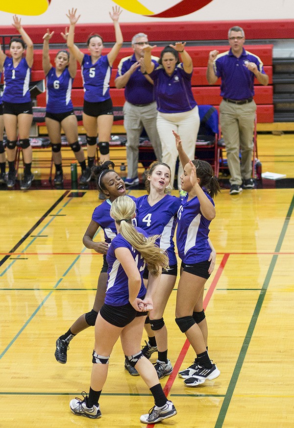 North Kitsap varsity volleyball players celebrate after scoring a point Nov. 8 during the 2A District Championship match against Liberty. North Kitsap won 3-0.