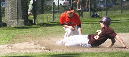 Central Kitsap High School third baseman Brett McDonald applies a tag to Gordy Anderson of South Kitsap High School during the Cougars’ 7-6 victory over the Wolves in a Narrows League tournament game Saturday at Heidelberg Park in Tacoma. The Cougars clinched a No. 3 seed to districts in the win.
