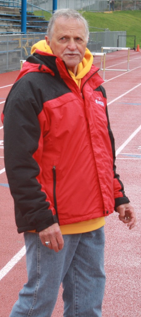 Lloyd Pugh watches Olympic College distance track practice last week.