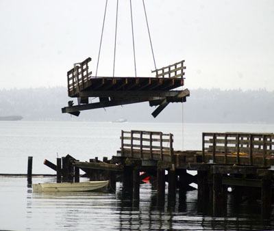 A section of the old Harper Pier is lifted up during dismantling and removal of the structure on Feb. 13.