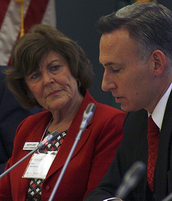 Bremerton Mayor Patty Lent listens to King County Executive Dow Constantine during a Puget Sound Regional Council meeting in Seattle Tuesday.