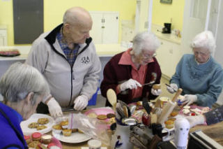 Seniors in Canterbury Care Center’s Adult Day Services program frost cupcakes to give to firefighters