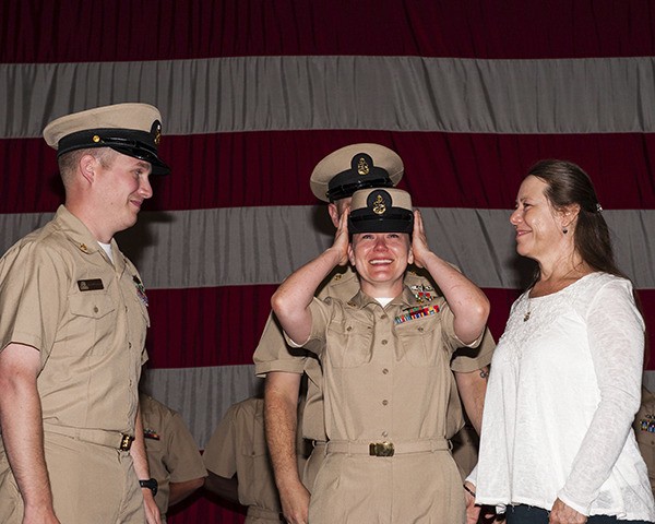 Chief Electrician's Mate Misty Moseley smiles after her cover was placed during a USS John C. Stennis (CVN 74) chief petty officer pinning ceremony at the gym on Naval Base Kitsap - Bremerton. Stennis is currently undergoing a Docking Planned Incremental Availability maintenance period at Puget Sound Naval Shipyard and Intermediate Maintenance Facility. (U.S. Navy Photo by Mass Communication Specialist 3rd Class Marco A. Villasana Jr.)