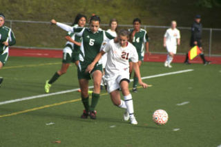 (Above) Central Kitsap junior Katie Smiley (21) battles for possession during the Lady Cougars’ 7-0 win over Foss to open the Narrows League Tournament. (Right) CK’s Hannah Anderson