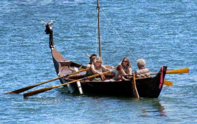 Poulsbo Vikings row a longboat in the Keys to Keyport fun paddle