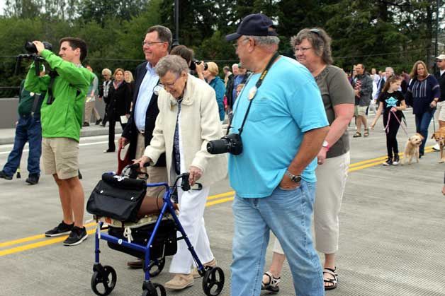 Kitsap County Commissioner Ed Wolfe (second from left) walks with residents of the Crista Shores assisted living community as the Bucklin Hill Bridge prepared to open to traffic on July 22. They were among the first to walk across the newly opened bridge.