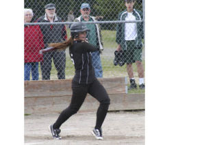 (Above) Klahowya’s Kazandra Holliday takes a swing during KSS’ 12-0 win against Bremerton at home Tuesday. Holliday was 4-for-5 at the plate. (Right) The Lady Eagles pounded out 15 hits to Bremerton’s one.
