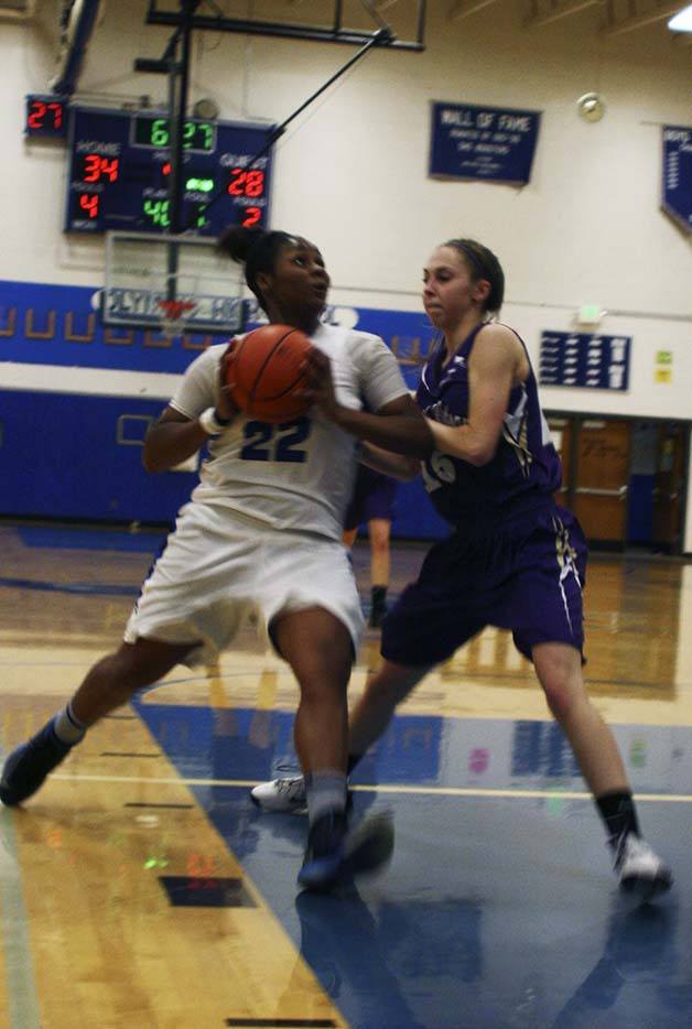 Olympic High School senior Olivia Williams drives to the basket for two of her 21 points Monday night.