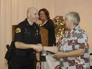 MADD Kitsap Chapter President Marsha Masters presents Bremerton Police Officer Donnell Rogers with a plaque honoring him for the 73 DUI arrests he made in 2007