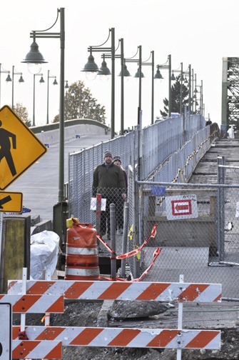 Brian Sullivan and Melissa Ripley cross the temporary pedestrian path built between the historic Manette Bridge and the newly constructed replacement Tuesday afternoon. The new span is expected to open at noon on Nov. 10.