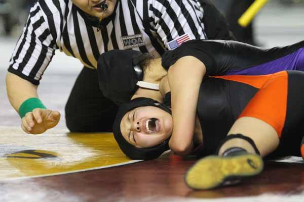 North Kitsap's Bella Livingston puts the hurt on Tiffany Hu before losing the first match of the 118-pound weight class bracket.