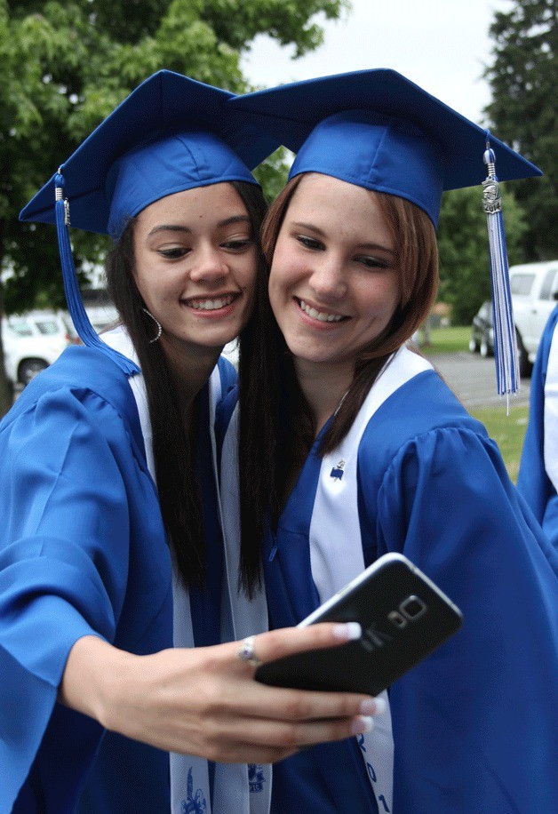 Taylor Curtin and Sinead Brown take a moment before graduation for a selfie. They were among the 281 students who graduated Saturday evening from Olympic High School.