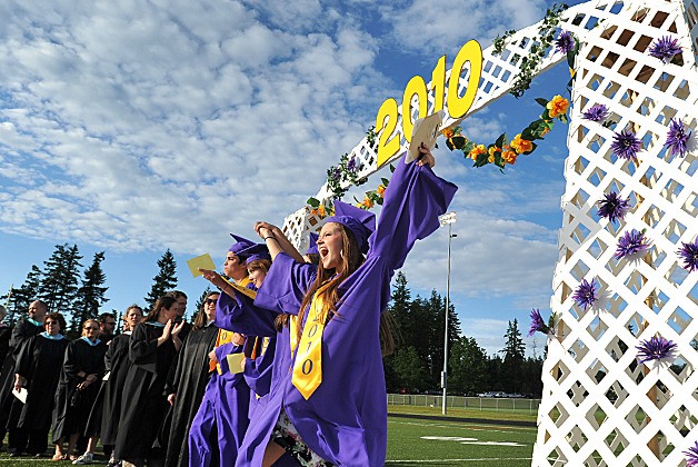 North Kitsap graduate Briana Mushinsky cheers as she passes under the  archway during ceremonies Friday at North Kitsap Stadium.