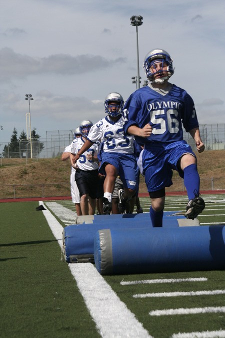 Members of the Olympic High School football team run an agility drill at practice last week.
